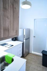 a kitchen with a sink and a refrigerator at Digital Nomad San Agustin Apartments in San Juan