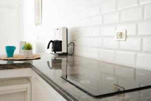 a kitchen with a counter top with a refrigerator at Marina Blue, Las Caletillas in Candelaria