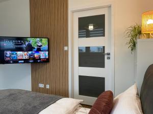 Zimmer mit einer Tür und einem TV an der Wand in der Unterkunft Ostrava Poruba Centre in Ostrava