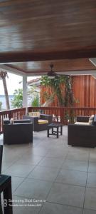 a patio with couches and tables on a deck at Villa #4 - Isla Contadora in Contadora