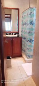 a bathroom with a sink and a mirror at Villa #4 - Isla Contadora in Contadora