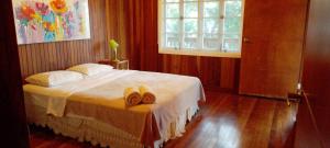 a bedroom with a bed with two towels on it at Villa #4 - Isla Contadora in Contadora