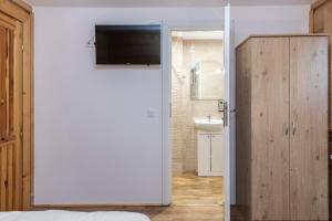 a bedroom with a bathroom with a sink and a mirror at Willa Serce Gór in Zakopane