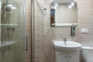 a bathroom with a sink and a glass shower at Willa Serce Gór in Zakopane