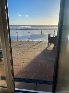a view of the ocean from a door at 3 Sinclair Bay Lodges in Keiss