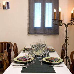 a table with wine glasses and plates on it at VILLA BELLUCIA in Cateri