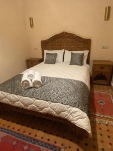 a bedroom with a large bed with towels on it at Riad Palais Marouane in Meknès
