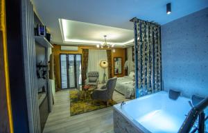 a bathroom with a tub and a bedroom with a bed at Hotel and Apartments Central City Prishtina in Prishtinë