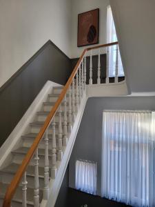 a staircase with white railings and a window at Brussels Bed & Blockchain Private rooms with shared bathroom in Brussels