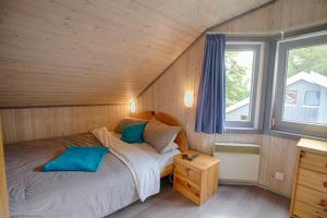 a small bedroom with a bed and a window at Ferienhaus Mirow 66 in Mirow