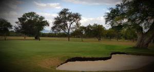 a golf course with a hole in the grass at K4T guest unit in Groblersdal