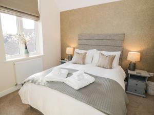 a bedroom with a bed with two towels on it at The Stokesay in Ludlow