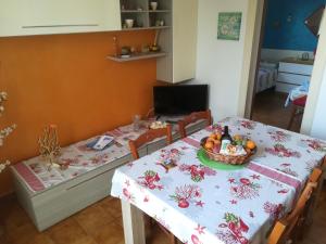 a dining room table with a bowl of fruit on it at Casa Claude in Casalabate