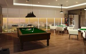 a room with a pool table and some tables and chairs at Luxury Sunset Views and Prime Location near CCP MOA with WIFI Parking in Manila