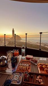 a buffet of food on a table with a view at Marina Casa Del Mar - Amazing Sea & Mosque views in Casablanca