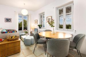 a living room with a table and chairs at Bralos Villa - Paros, Sea View in Kóstos +9 photos