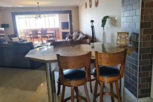 a kitchen and living room with a table and chairs at Swakopmund holiday Apartment in Swakopmund +8 photos