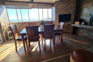 a dining room with a wooden table and chairs at Swakopmund holiday Apartment in Swakopmund