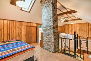 a room with a brick chimney and a bed in it at Cozy Wilcox Home on East Branch of Clarion River! in Wilcox