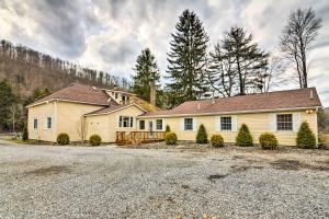 a large yellow house with a driveway at Cozy Wilcox Home on East Branch of Clarion River! in Wilcox