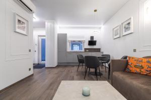 a living room with a couch and a table at Amber Stone Apartment 1st floor in Palanga +10 photos