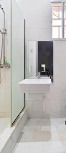 a bathroom with a sink and a glass shower at Exclusive Upscale 1 Bedroom Apartment in Lekki phase 1 in Lagos