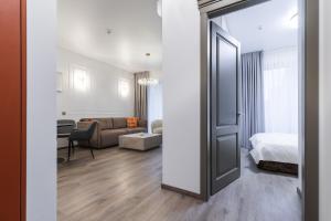 an open door to a room with a bed and a living room at Amber Stone Apartment 1st floor in Palanga