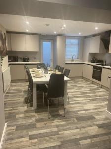 a kitchen with a table and chairs in a room at Rivendell Modern 2 Bedroom apartment in St Peters village sleeps 6 in Kent