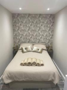 a bedroom with a large bed with two pillows at Rivendell Modern 2 Bedroom apartment in St Peters village sleeps 6 in Kent