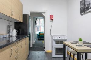 a kitchen with a counter and a table in it at Home in Levenshulme, Manchester in Manchester