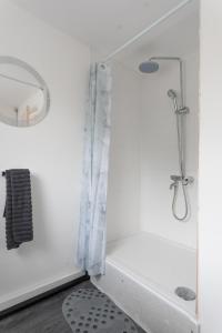 a white bathroom with a shower and a sink at Home in Levenshulme, Manchester in Manchester