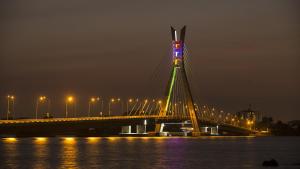 a bridge over the water at night with lights at Exclusive Upscale 1 Bedroom Apartment in Lekki phase 1 in Lagos