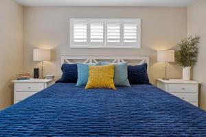 a bedroom with a blue bed with blue pillows at Hillcrest Haven in Morro Bay