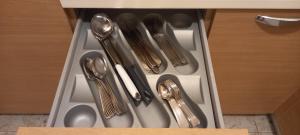 a drawer with silver utensils in a cabinet at Marys Home Apartment Međugorje in Međugorje