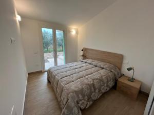 a bedroom with a bed and a large window at Agriturismo La Quercia dei Tigli in Forlì +131 photos