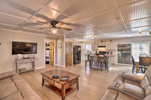 a living room with a couch and a table at Lakefront Greers Ferry Cabin with Covered Boat Slip! in Fairfield Bay