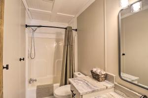 a bathroom with a shower and a toilet and a sink at Lakefront Greers Ferry Cabin with Covered Boat Slip! in Fairfield Bay +25 photos
