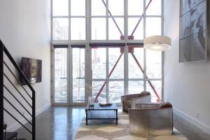 a living room with chairs and a large window at Duplex Suite in Art Tower in Philadelphia