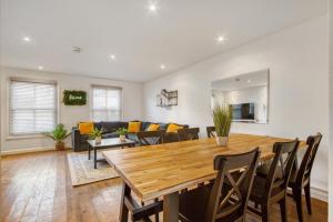 a dining room and living room with a wooden table and chairs at Shoreditch Balcony 2 BDR Apartment in London