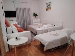 a living room with two beds and a couch at Marys Home Apartment Međugorje in Međugorje
