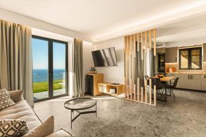 a living room with a view of the ocean at Mani Theasis in Stoupa