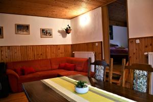 a living room with a couch and a table at Apartments Lenc in Bovec