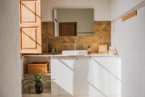 a bathroom with a sink and a mirror at Agroturismo Son Boronat in Calvià