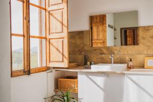 a bathroom with a sink and a mirror at Agroturismo Son Boronat in Calvià