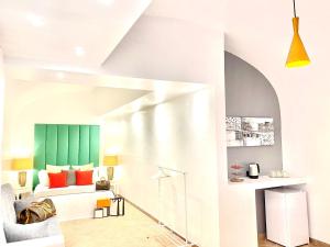 a living room with a bed and a green wall at Palace Fontana di trevi Apartments in Rome