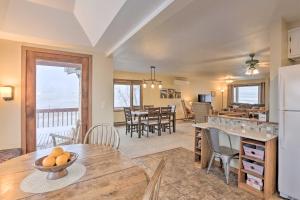 a kitchen and living room with a table and chairs at Rapid City Vacation Home with Wraparound Deck! in Rapid City