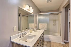 a bathroom with two sinks and a large mirror at Rapid City Vacation Home with Wraparound Deck! in Rapid City +37 photos
