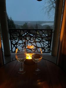dos copas de vino sentadas en una mesa con vistas en Tó Kincse Vendégház, en Kustánszeg