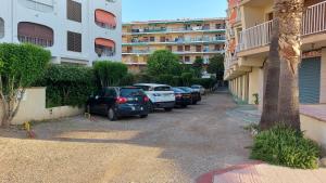 a row of cars parked in a parking lot next to buildings at BELLAMAR 25 in Cambrils
