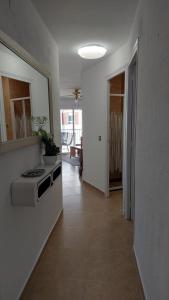 a kitchen with a stove and a hallway with at BELLAMAR 25 in Cambrils